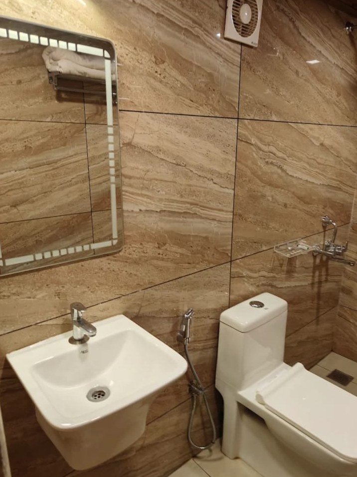 Clean bathroom with wash basin and shower spray